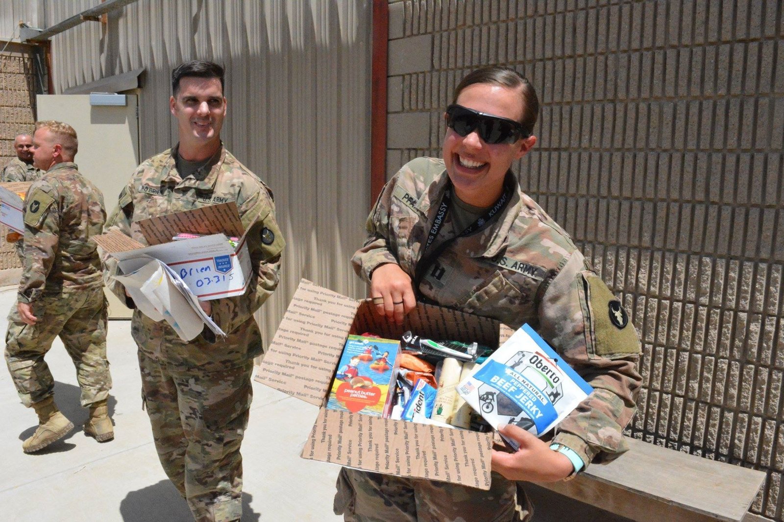 army soldiers holding care packages overseas